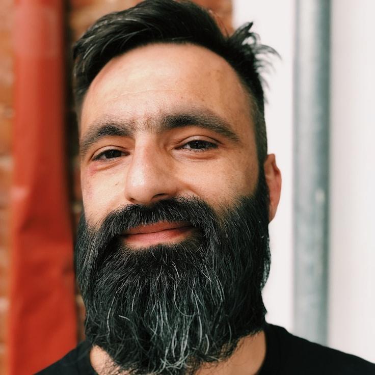 Kaveri Mehta, Lead Design Curator at QuietGroveAtlas, reviewing corporate floral arrangements